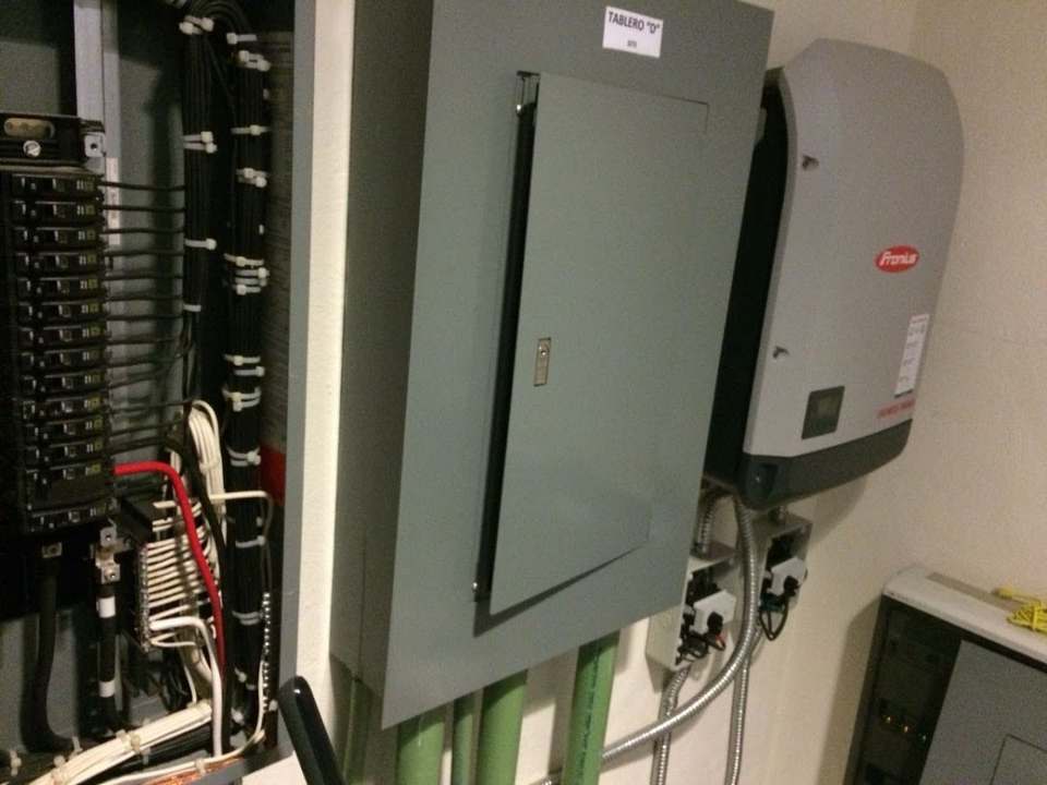 GreenSun engineer reviewing inverter and electrical equipment